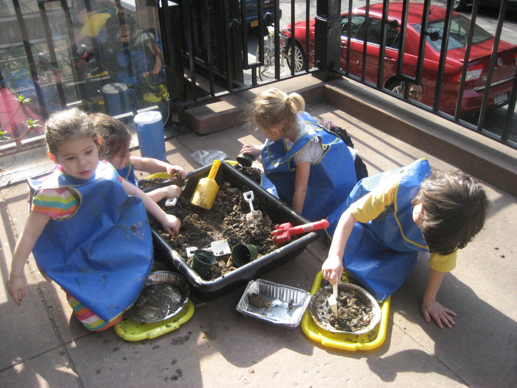 Sophie, Talia, Vivian and Gaby begin work on their mudpies.